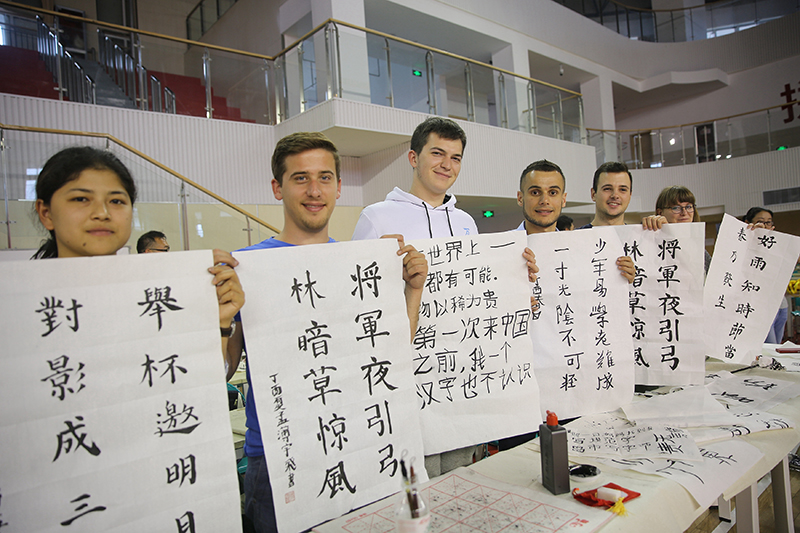 2017年6月5日，來自青島大學(xué)和中國石油大學(xué)（華東）的外國留學(xué)生在展示剛剛現(xiàn)場完成的書法作品。